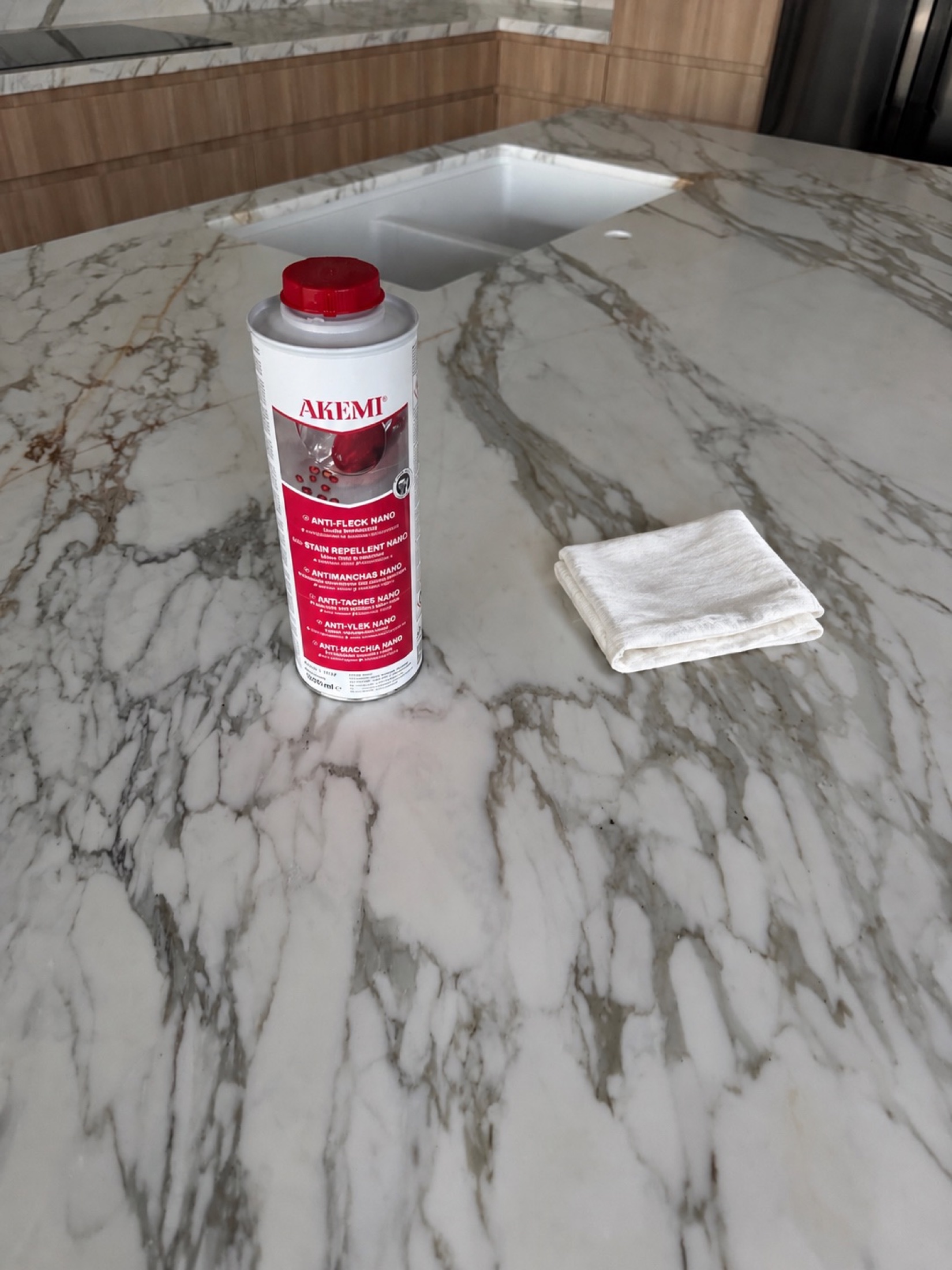 Stone care product and polishing cloth on a veined benchtop